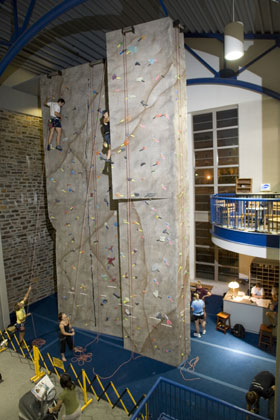 Students work on the new climbing wall in Wilson Gym. 