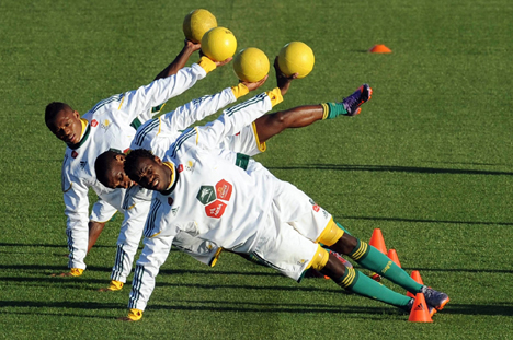 Members of the South African national soccer team warm up before a pre-World Cup practice. 