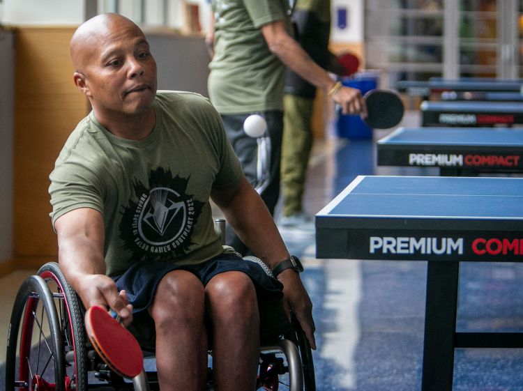 Jackie Jones, 54, of Winston Salem returns a table tennis serve. “This is the first time I’ve played [table tennis] since being paralyzed,” said Jones, who suffered a spinal stroke in 2019. “It came back to me like riding a bike.”