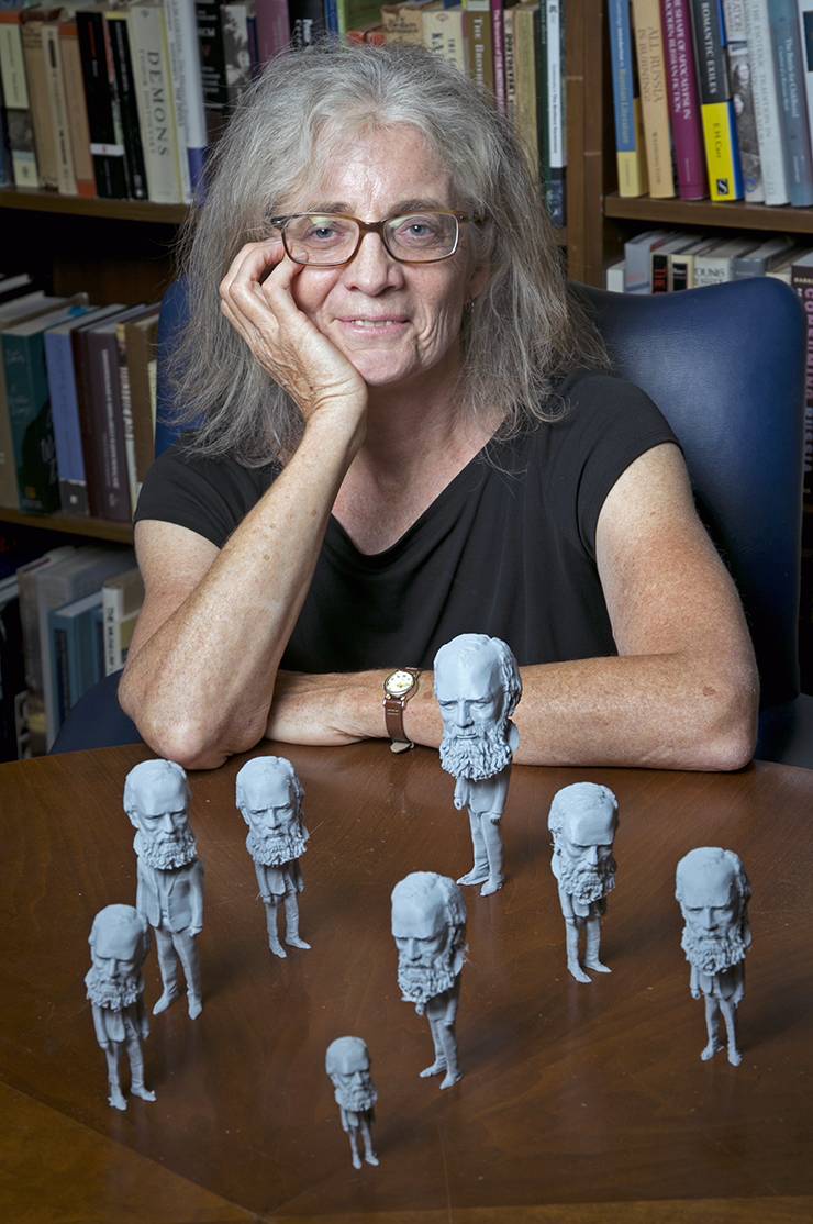 Carol Apollonio sits with the Fyodor Dostoevsky figures she and her students printed with help from the Co-Lab Studio.