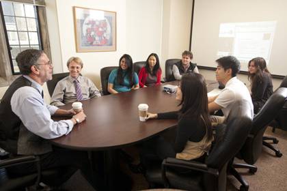 Professor Harris Cooper, left, leads a discussion about student research projects.  Photo by Les Todd/Duke University Photography