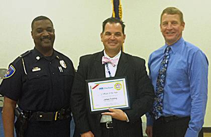 Duke Police Investigator James Fickling, center, shows his Officer of the Year award he received as part of the Duke Crisis Intervention Team. Photo courtesy of Duke Police.