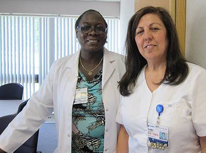 Sevda Mirza (right), clinical team lead at Duke Regional Hospital, recognized her colleague Pauline Stroud recently for being a mentor to her and others in her unit.