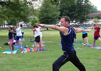 David Roberts, a Duke fitness instructor teaching part of this summer's yoga series for Duke employees, leads a workshop on campus. Photo by Bryan Roth