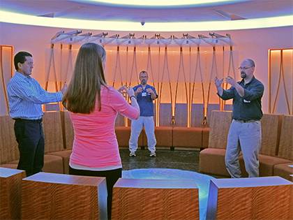 John Hillson, right, leads patients, staff and visitors through Tai Chi movements in the Duke Cancer Center's Quiet Room.  Photo by Marsha A. Green. 