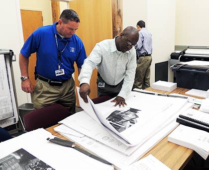 Thomas Kelly, manager of housekeeping services, and Albert Scott, right, review West Union renovation plans. Photo courtesy of Albert Scott
