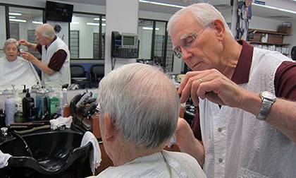 David Fowler, right, the manager of Duke Barber Shop, has worked at the university for 55 years. Photo by Alexandria Sampson