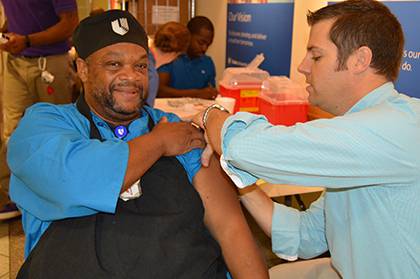 Milton Hux, who works in the Duke Hospital cafeteria, receives his flu shot this year.