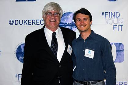 Mike Forbes, left, poses for a photo with undergraduate Alex Kunycky, president of the school’s ski and snowboard team, during Duke’s annual sports clubs award banquet in April. Forbes said working with students makes being at Duke his dream job. Pho