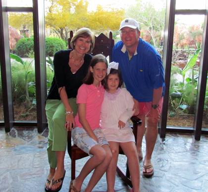 Hank Woods, right, posts with his wife, Mendy, and daughters Addison and Finley during a family vacation. Woods said he loves spending time with his family outside of work, especially wathcing his girls ride horses. Photo courtesy of Hank Woods.