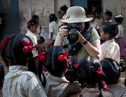 Marilyn Telen stops to photograph a group of Indian school kids during a visit to the country in August 2015. Photo courtesy of Marilyn Telen.
