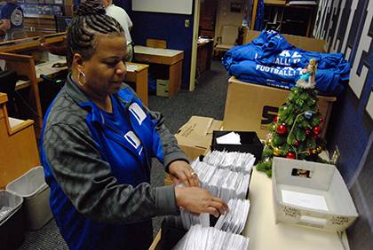 Shelia Allen sorts through ticket hold requests at her office in Cameron Indoor Stadium. Photo by Bryan Roth.