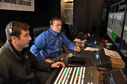 Mike Cappetto, left, and Chad Lampman run through tests prior to a recent online broadcast of a field hockey game on ESPN3. Duke Athletics recently began using its own production trailer to broadcast Duke sports. Photo by Bryan Roth.