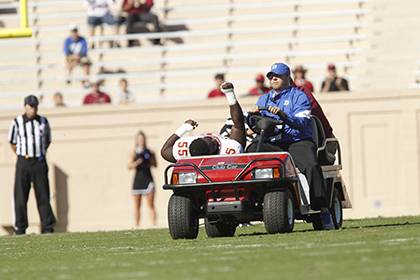 Bob Weiseman, assistant athletic director for athletic facilities, game operations, and championships, drives an injured Florida State University football player off the field at Wallace Wade Stadium. Weiseman serves a variety of roles to oversee athleti
