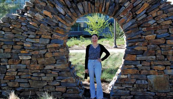 Brittany Hunt stands in front of a stone archway located in front of the Nicholas School of the Environment. Hunt is one of 324 Duke faculty and staff who identify as American Indian or Alaskan natives. Photo by Jack Frederick.