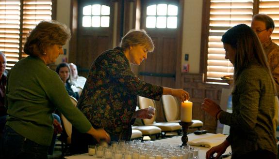 Pastors light candles as part of a ceremony at the start of the Spirited Life Intervention program.
