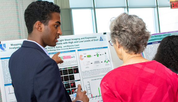 Graduate students in the Duke Summer Research Opportunity Program present their research at a poster session