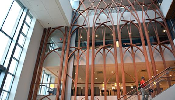 The Duke Cancer Center lobby has a feature wall that pays homage to Duke Chapel archways as well as North Carolina trees. Photo by April Dudash
