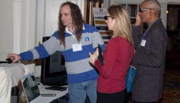 Stephen Toback of Duke's Office of Information Technology (left) demonstrates 3-D and other technologies at Duke's fifth annual Tech Expo.