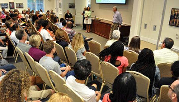 At the front of the room, Nikki Baskin, left, and Christoph Guttentag, right, with Duke Admissions discuss the importance of creating a college list and meeting with guidance counselors during "College Admissions 101" Tuesday. The seminar was for Duke em