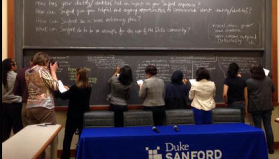Sanford School community members write answers to prompts about race and justice in a town hall this week.