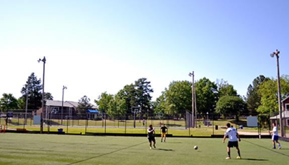 Members of the Duke "Soccer Fridays" group kick around a soccer ball after work. Photo by April Dudash