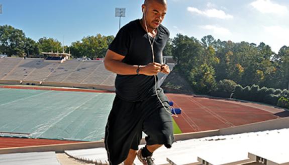 Tevante Clark, a Duke employee depdendent, runs steps at Wallace Wade Stadium. With help from Duke health management programs, he's lost over 200 pounds in the past two years. Photo by Bryan Roth.