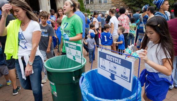 Becky Hoeffler, center, program coordinator with Sustainable Duke, helps coordinate Duke's "zero waste" effort outside Brooks Field at Wallace Wade Stadium during this year's Employee Kickoff Celebration.