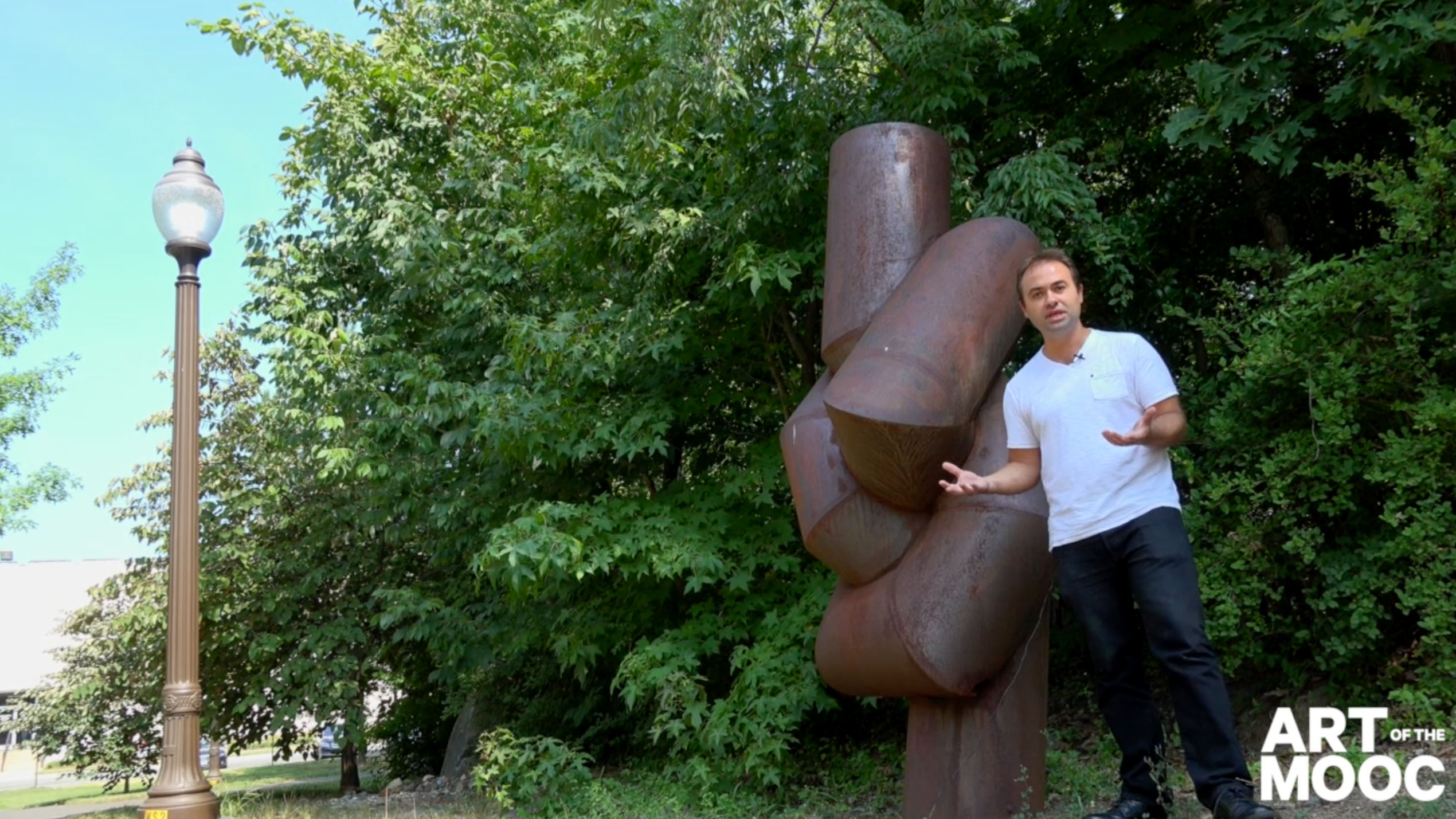 Pedro Lasch gestures next to an outdoor scehdule.