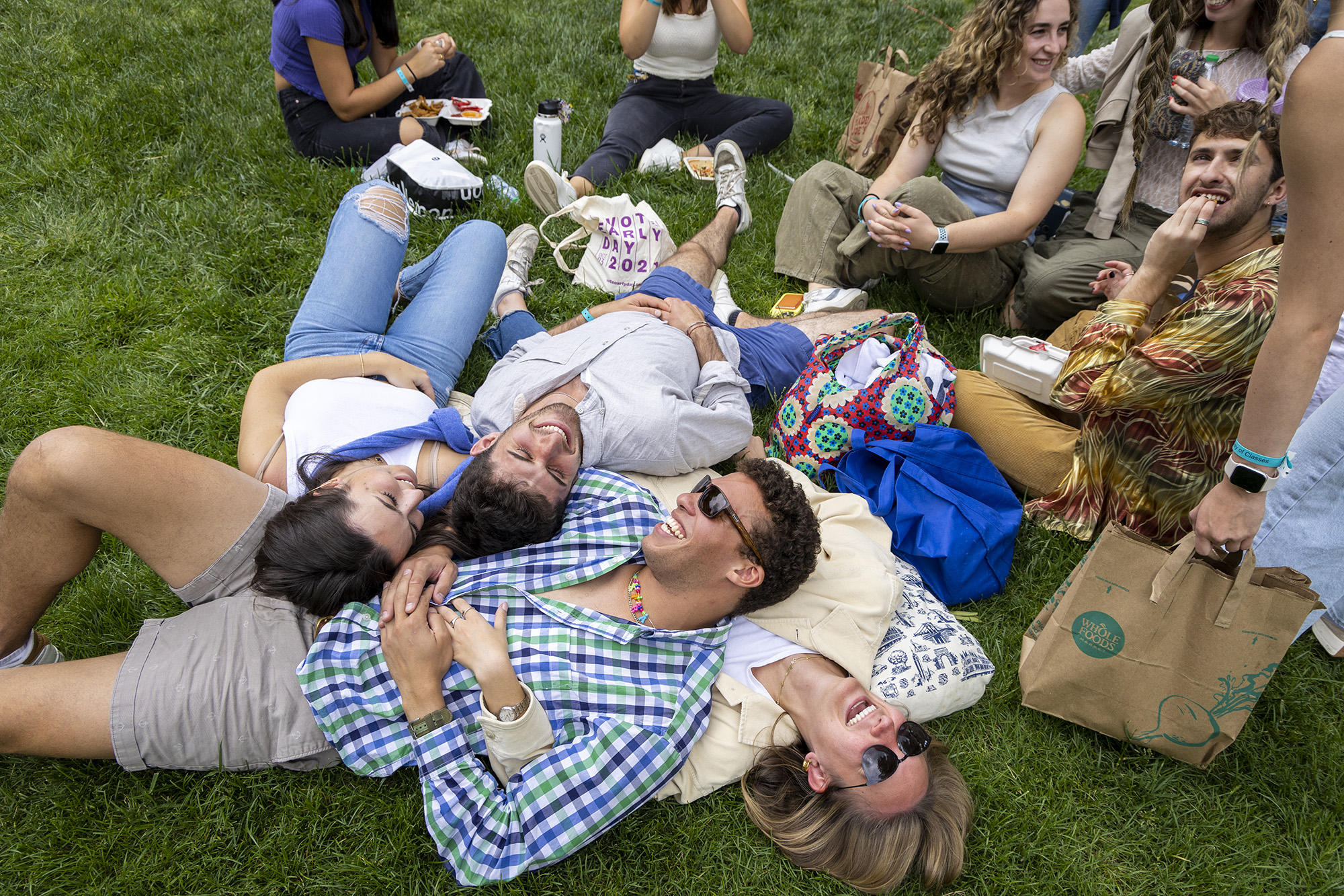 Seniors Nancy Beaujeu-Dufour, Ian Acriche, Chase Pellegrini de Paur and Lana Gesinsky lay on the grass together on the Abele Quad lawn. 