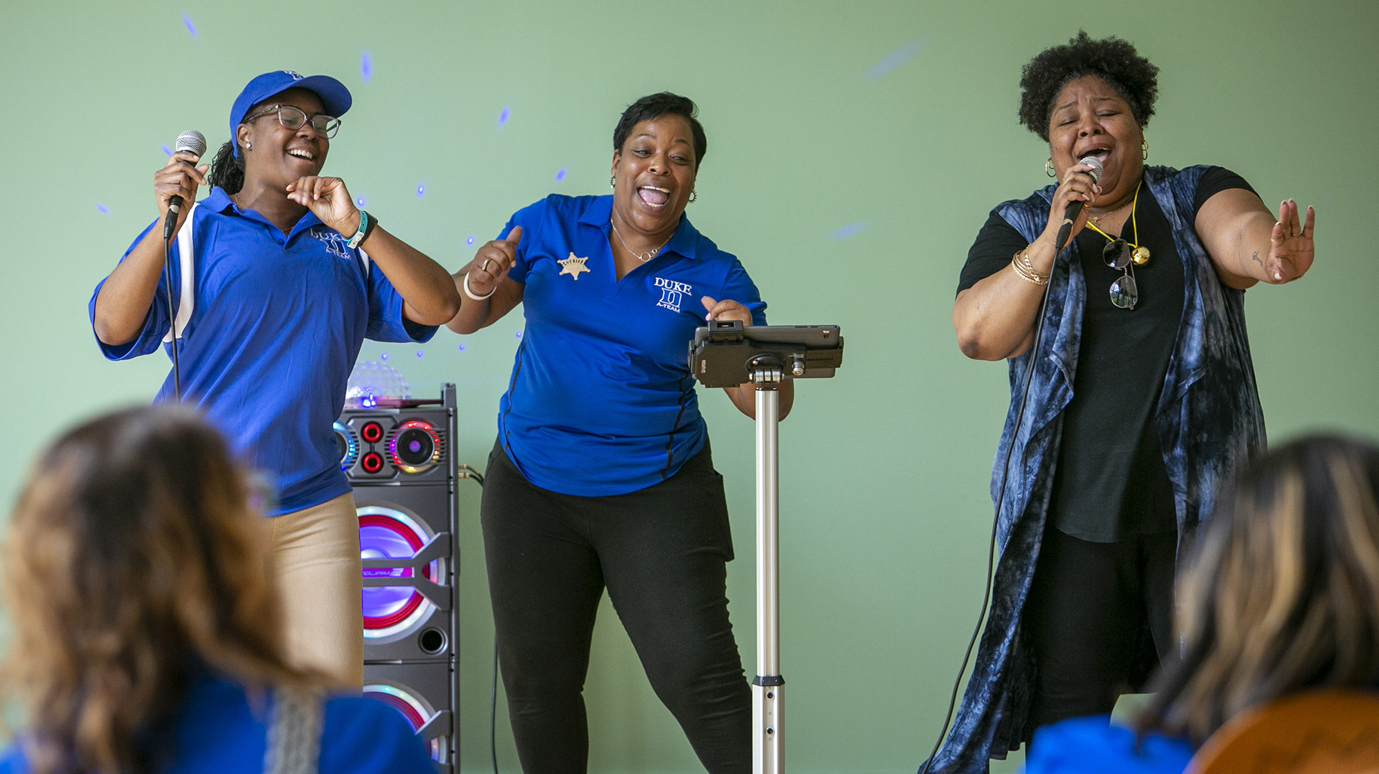 Student Affairs staff, from left, Tai Louder, Joie Foust and Michelle Johnson entertain with their karaoke rendition of 24K Magic by Bruno Mars during LDOC.