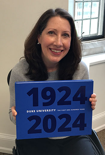 Carolyn Gerber with the centennial book “Duke University: The First One Hundred Years.”