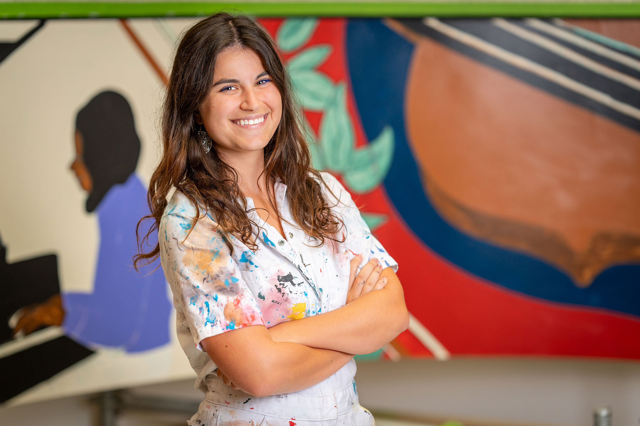 Natalie Robinson in front of her mural