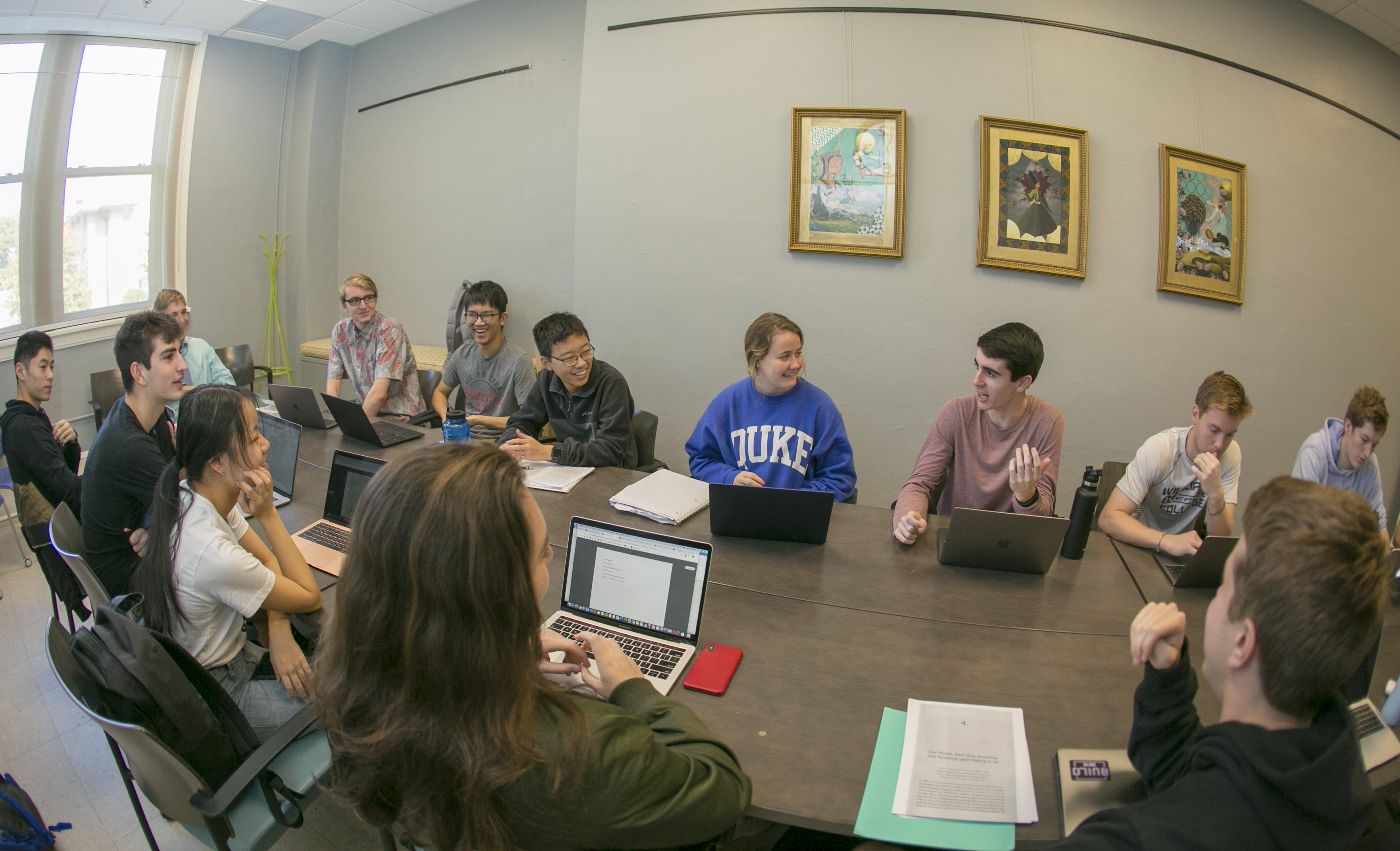 Students smiling and talking in a classroom