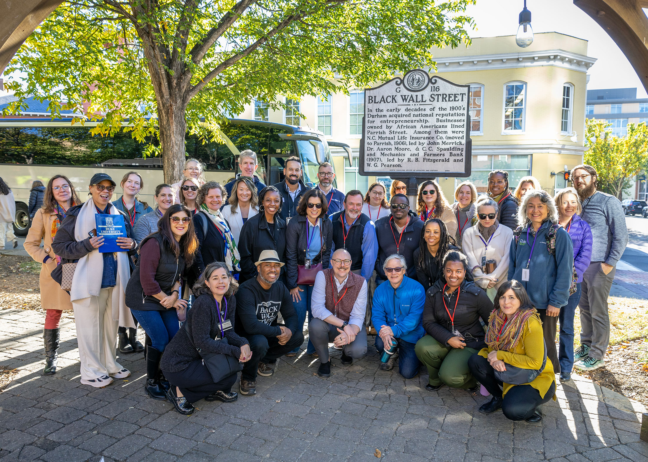 The tour stopped in front of the Black Wall Street plaque in downtown Durham.