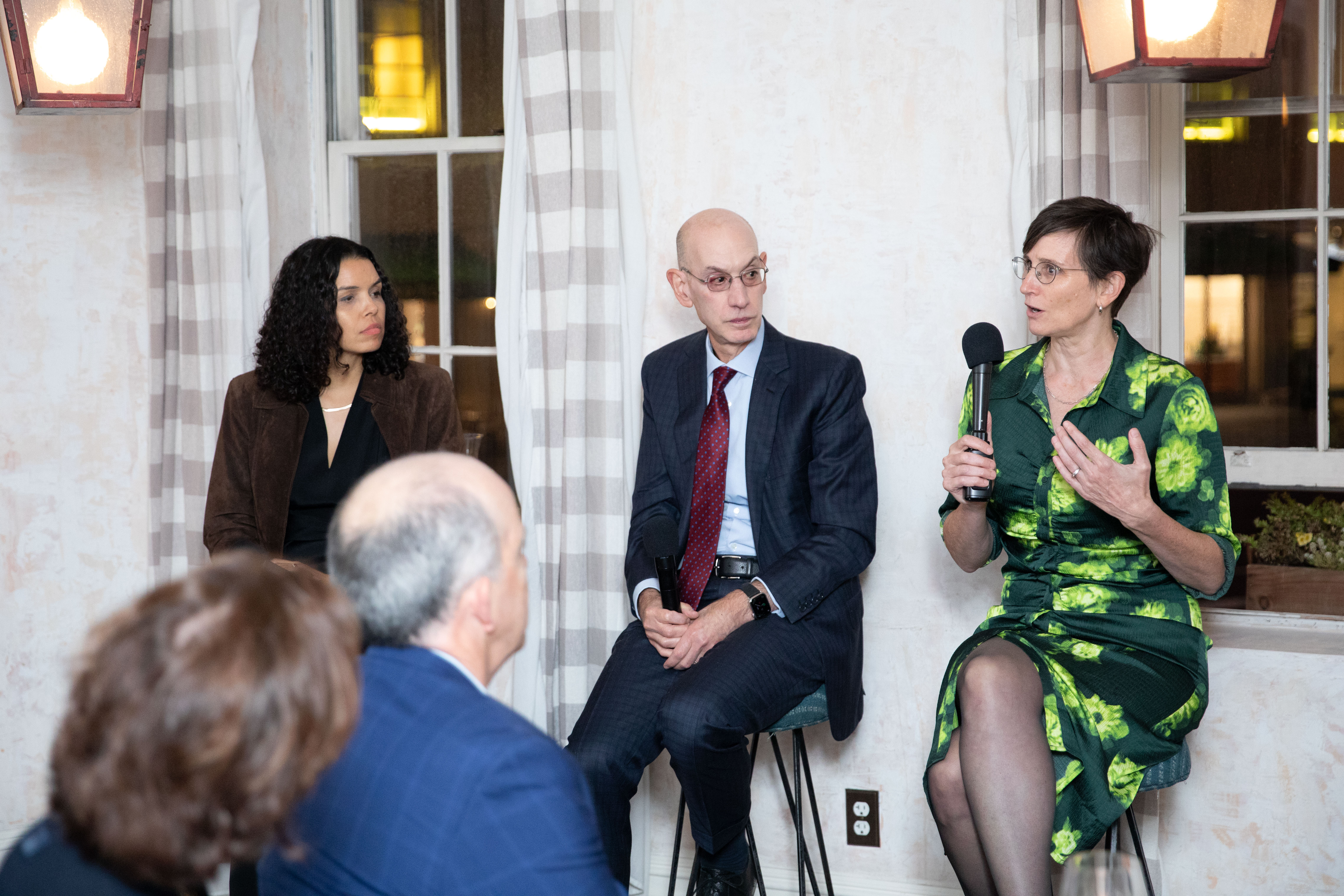 Toddi Steelman, Adam Silver and Morgan Harper sitting on stools in front of room for a panel discussion on climate change at a SALA series event in New York