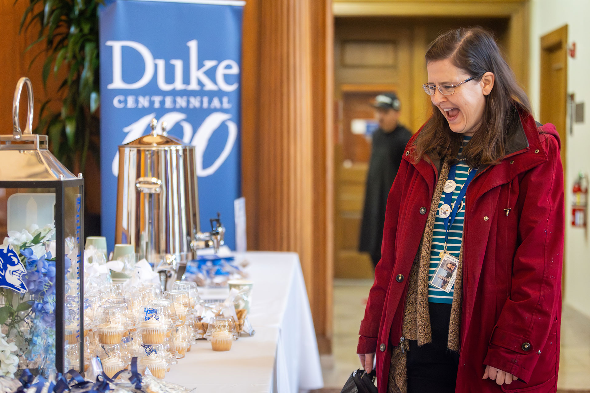 Lauren Crowell of Duke Libraries shows delight at the holiday decorations at the Wall Center.