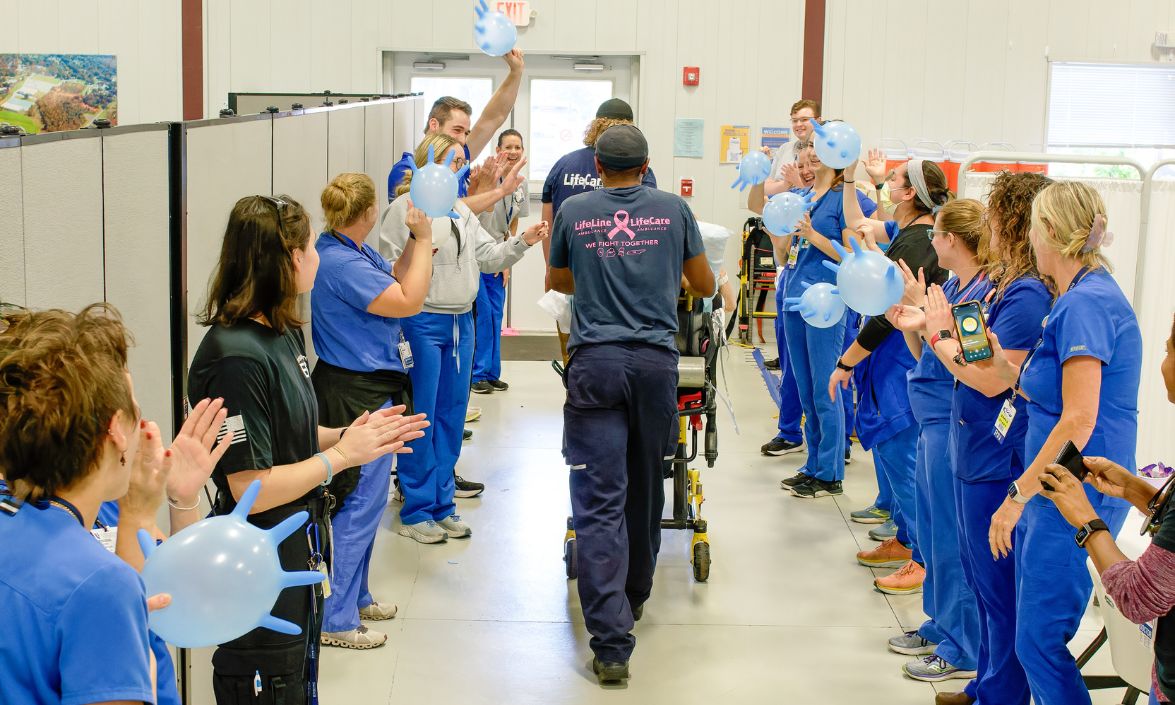 Medical staff clapping as people leave facility