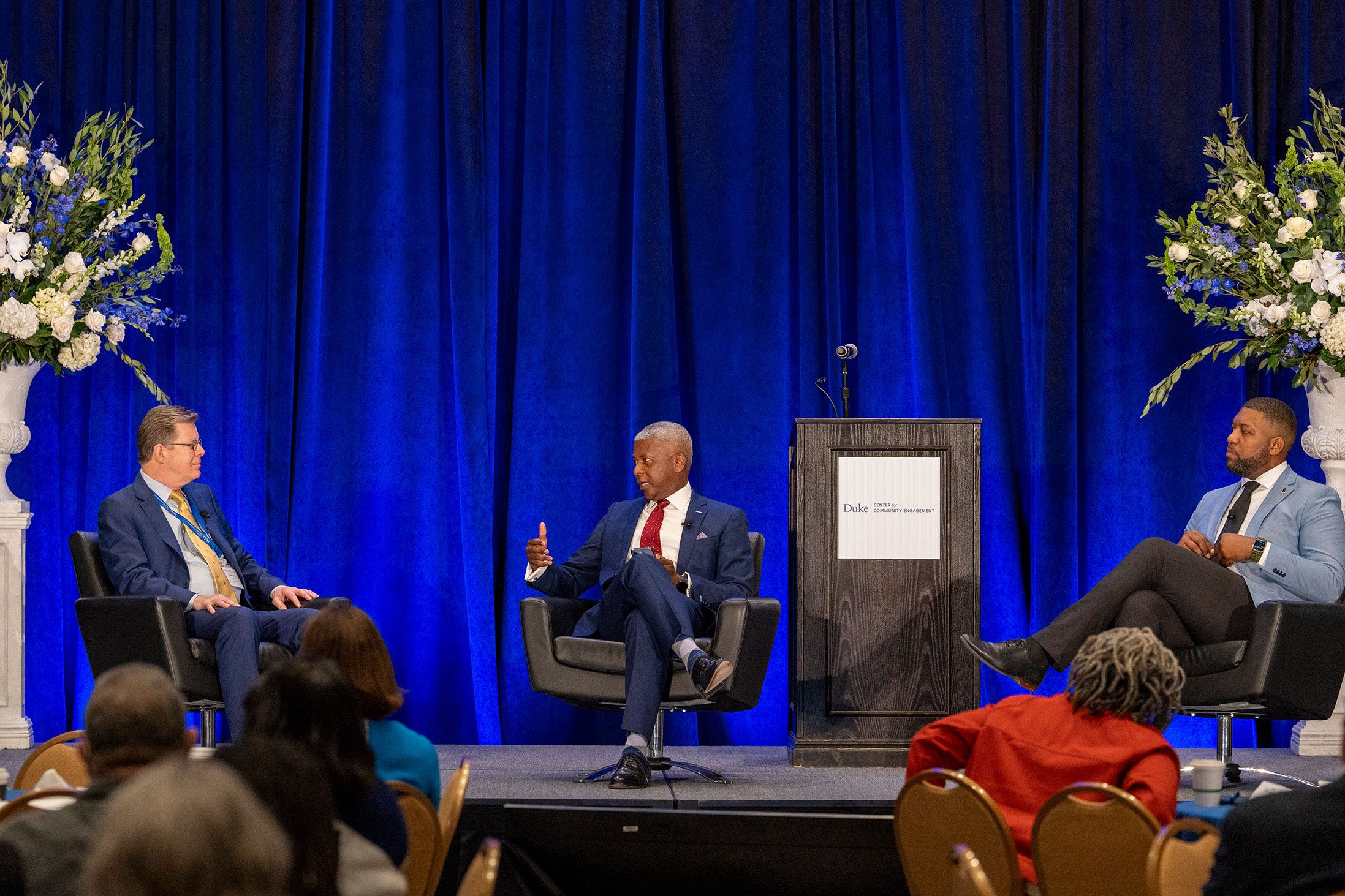 Duke President Vincent Price converses with moderator John Simpkins and Durham Mayor Leonardo Williams.