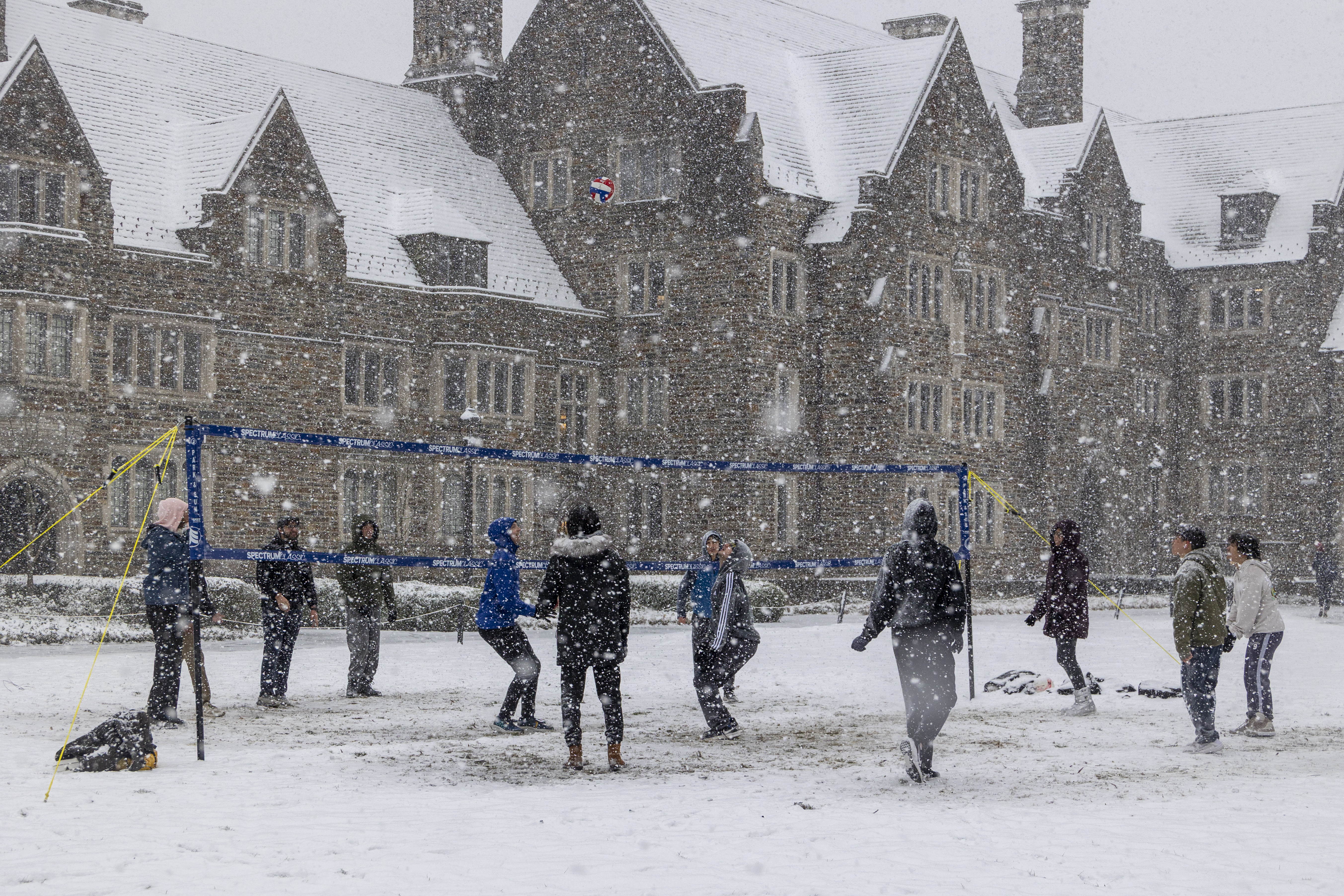 A volleyball game breaks out in the snow on West Campus