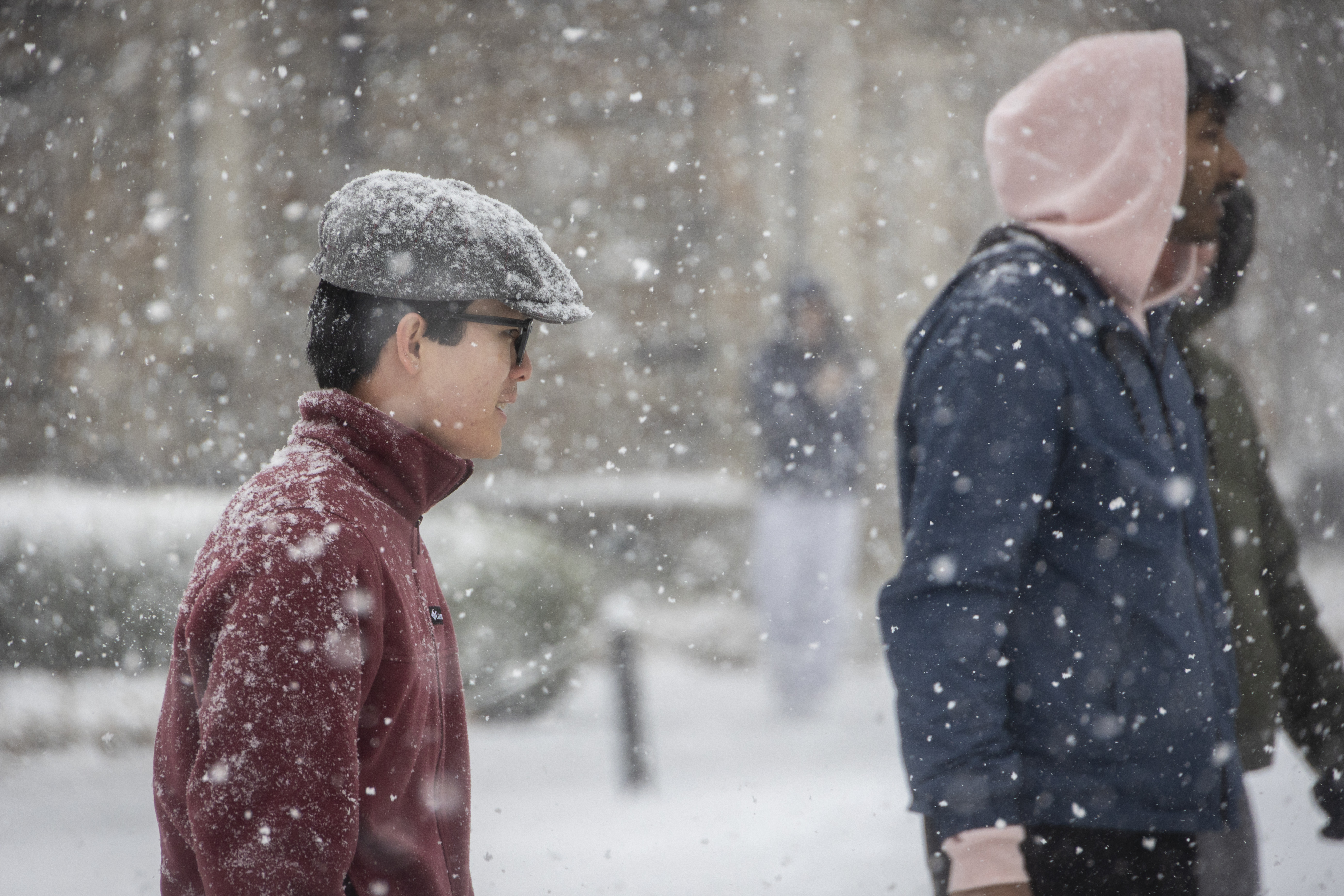 Two male students walking through the snow on West Campus
