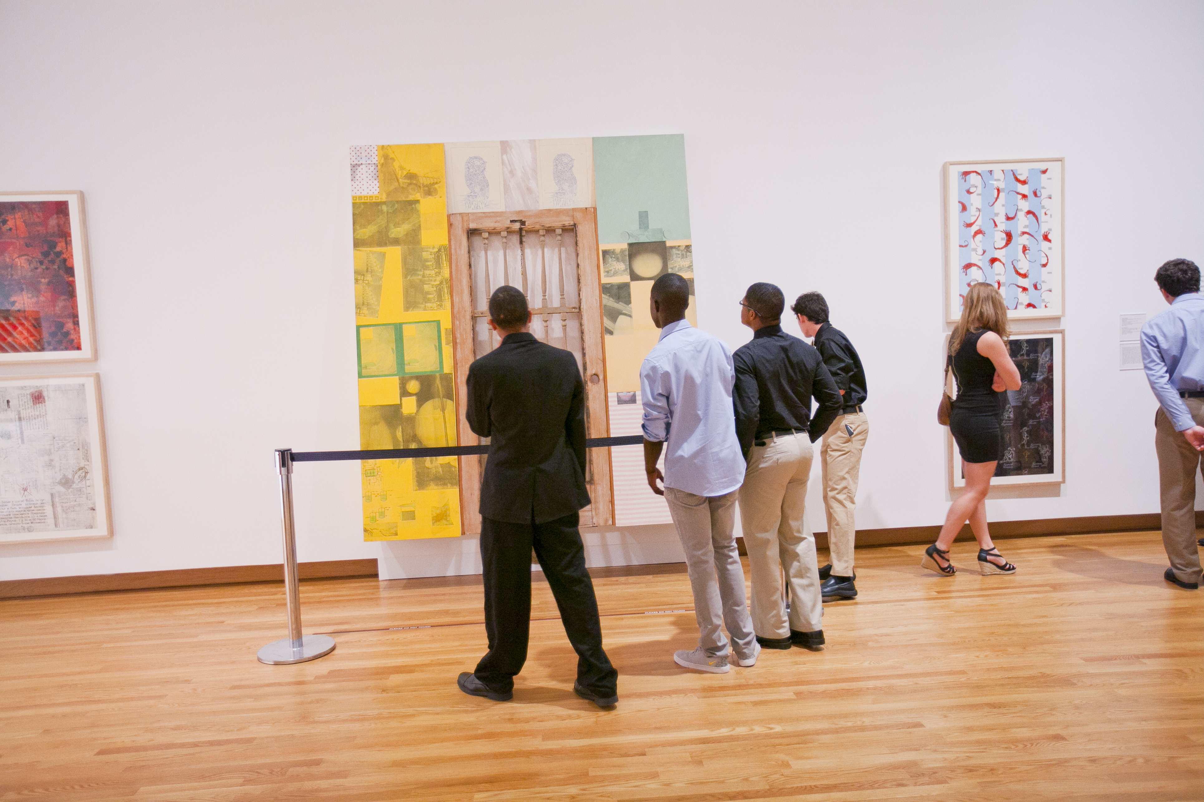 A group of people looks at an art display hung on a wall at Nasher Museum of Art