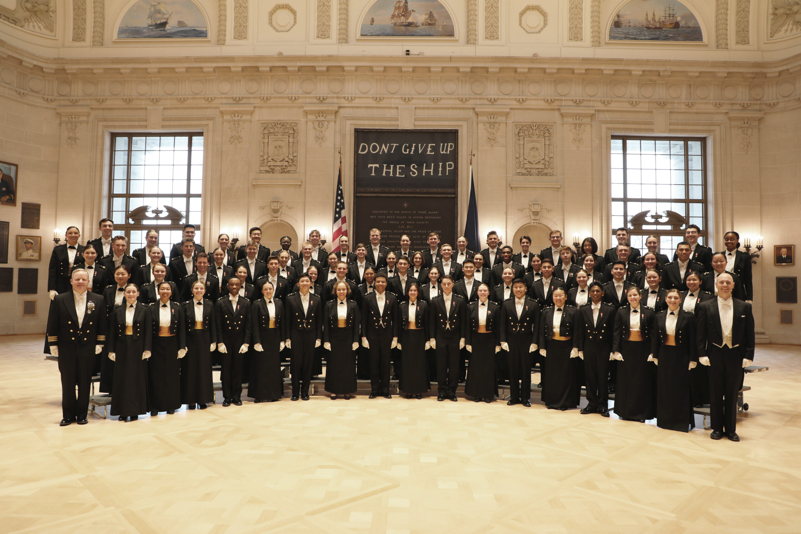 Members of the U.S. Naval Academy Glee Club stand in a formal portrait