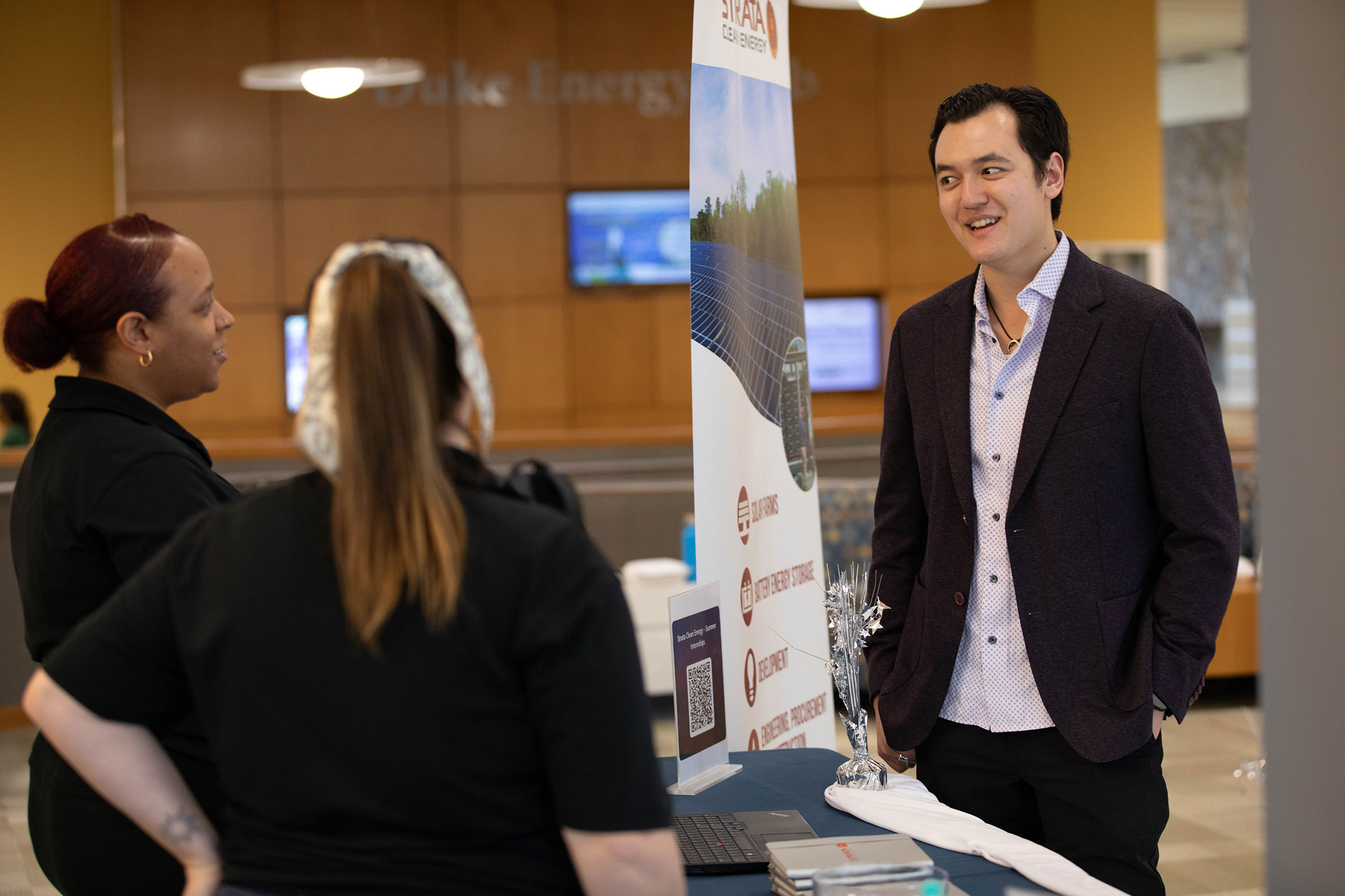 Tyler Ratcliffe talks with participants at the Energy Climate Fair.