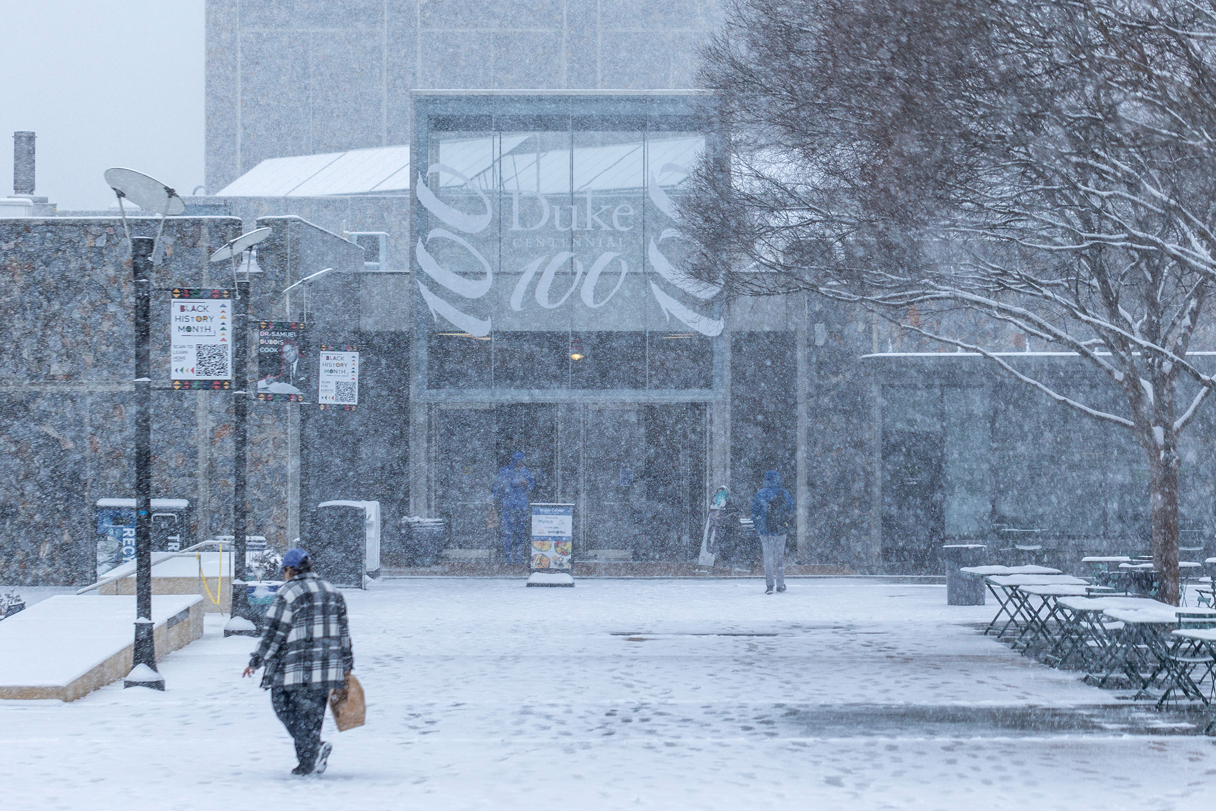 In the early hours of the snow, the fall begins to stick on the Bryan Center plaza