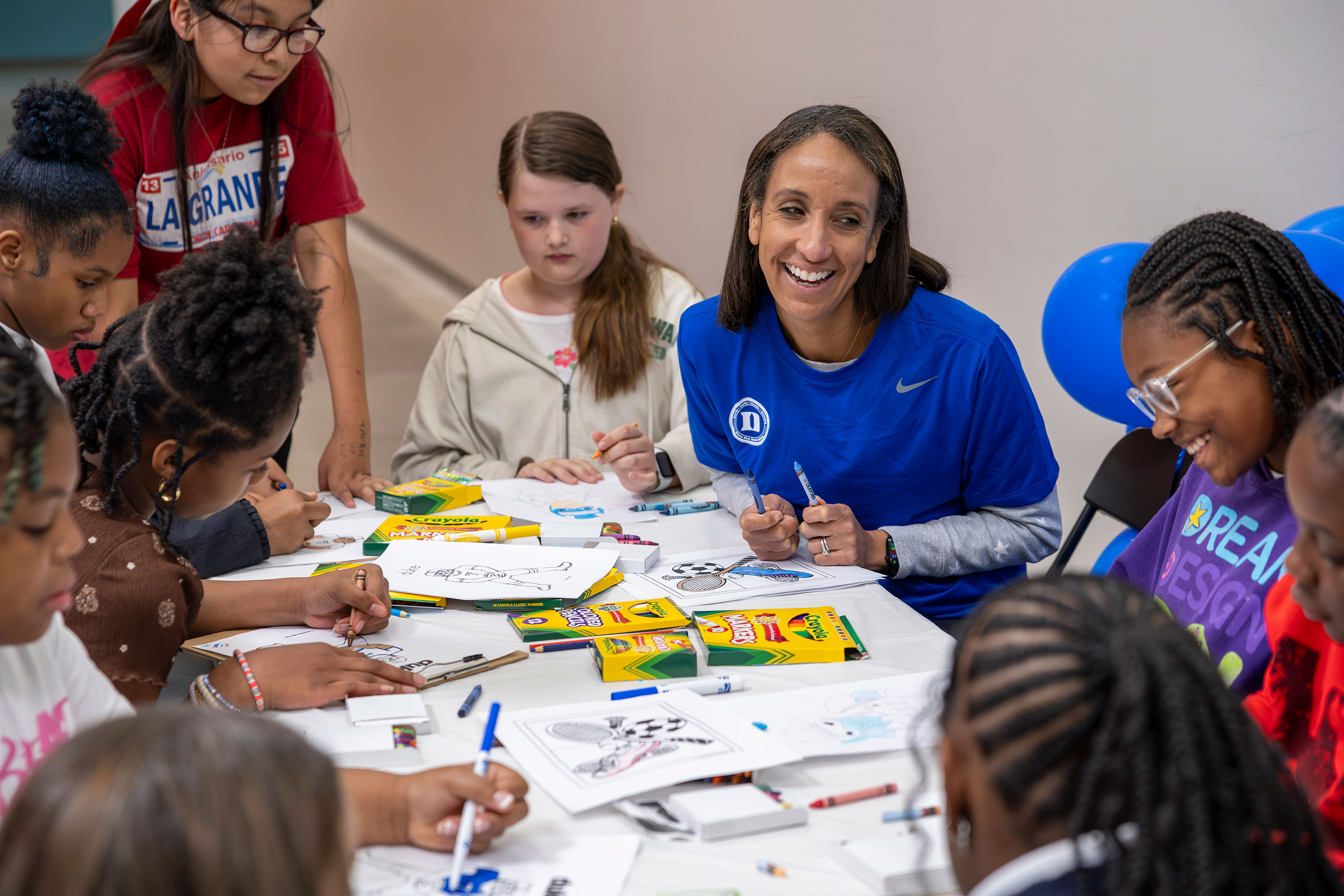 Nina King encourages young students and they do drawing activities.