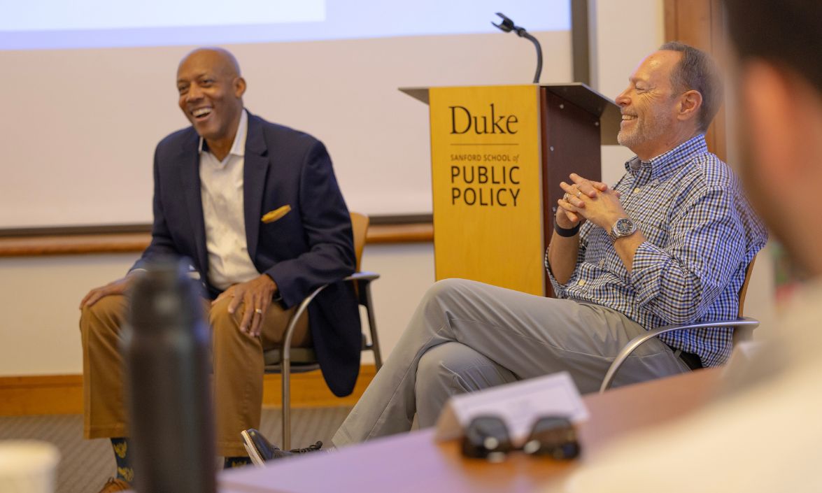 Two people sitting and smiling