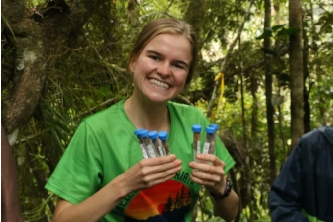 Photo of Camille DeSisto with test tubes of fecal samples.