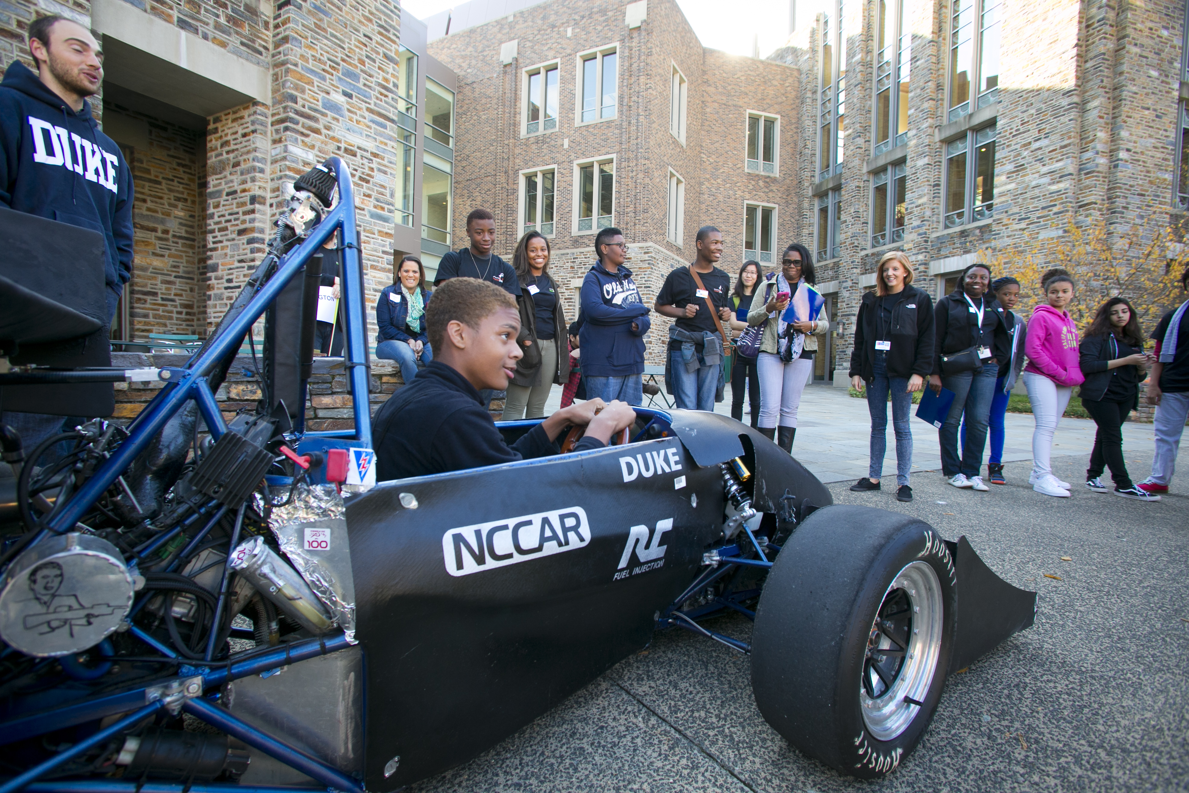 Student sits in race car