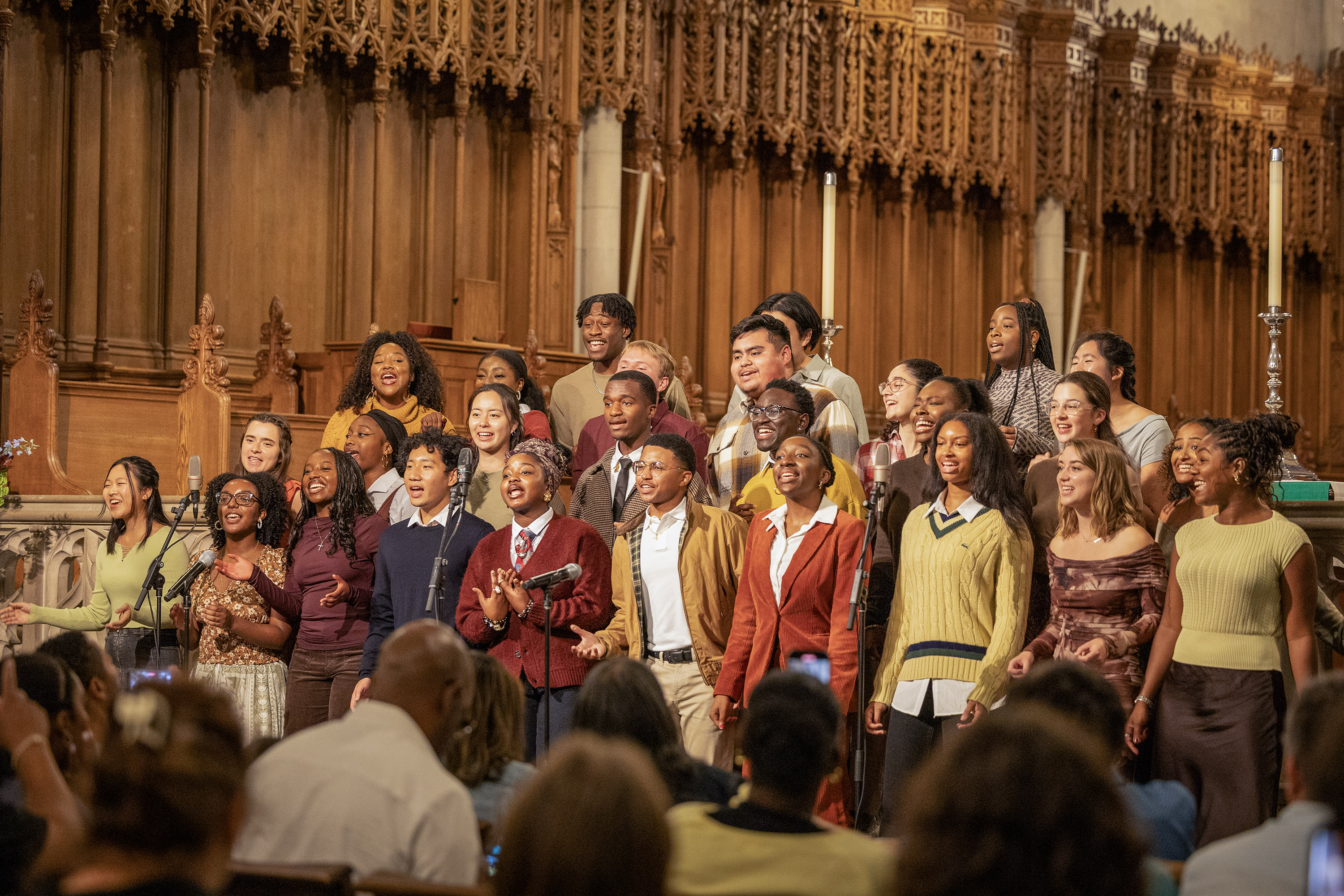 Group of students singing together in the chapel